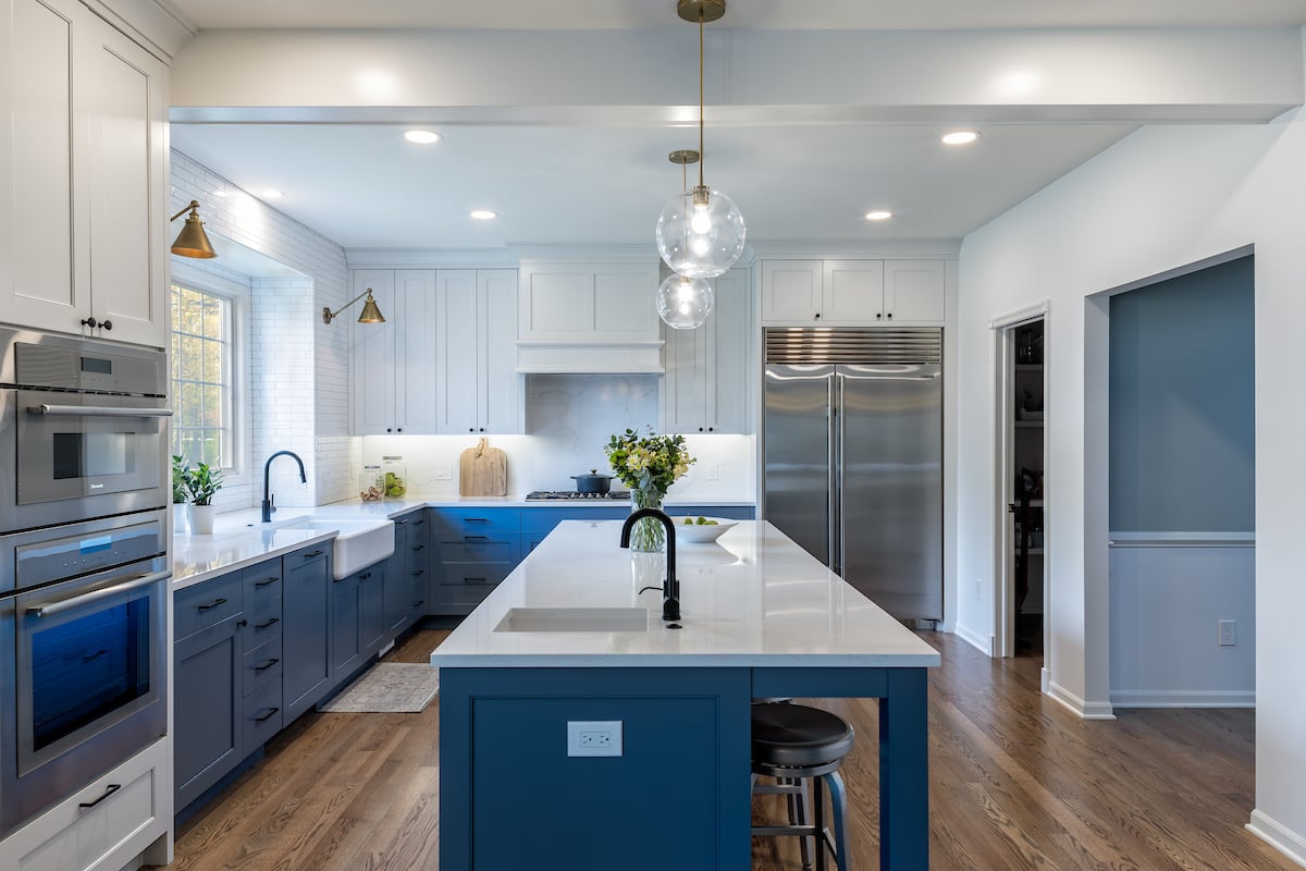 kitchen renovation on 90s home with blue and white kitchen cabinets